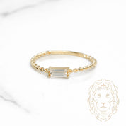 Bague - Or 10K jaune twist & pierre cz coupe baguette - RIG1120